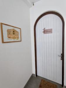 a white door with a sign that reads peace at VYA homestay Huế in Thôn Lại Thê