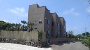 a building with a fence in front of it at Sopoong in Jeju