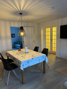 a dining room table with chairs and a light fixture at Casa Home of Bricks - Downtown Holidays in Billund