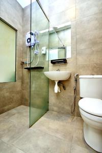 a bathroom with a toilet and a sink and a shower at Cojoy Hotel @ Chinatown in Kuala Lumpur