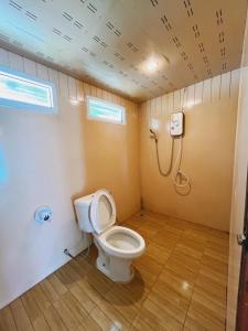 a bathroom with a toilet and a shower at Wangsarai Resort in Don Sak