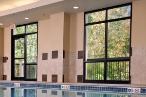 a swimming pool with windows in a building at Courtyard Boston Woburn/Boston North in Woburn