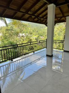 a balcony with a view of a mountain at The Kandyan Secret Villa - Free Pick up From Kandy Railway Station in Kandy