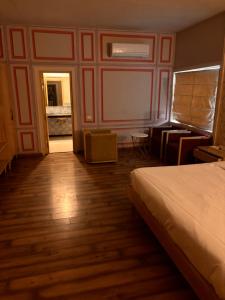a hotel room with a bed and a desk and a bedroom at Hotel MEHAI HOUSE in Jaipur