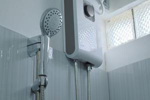 a shower in a bathroom with a shower head at Point Vista Transient Accomodation in Daet