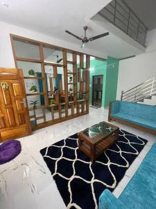 a living room with a couch and a coffee table at Vacation Guest House in Trivandrum
