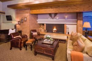 a living room with a fireplace and a couch at Mountain Chalet Snowmass in Snowmass Village