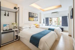 duas camas num quarto de hotel com um quarto em Cabana Hotel - 5 Truong Dinh, Q1 - by Bay Luxury em Ho Chi Minh