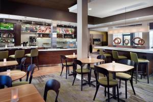 a restaurant with tables and chairs and a bar at Courtyard by Marriott Macon in Macon