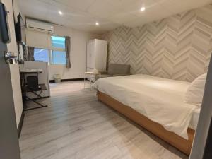 Kama o mga kama sa kuwarto sa 新獅城商務旅館New Lion City Hotel