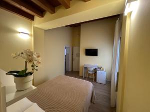 a room with a bed and a table with a tv at Laguna Blu Mestre Venezia in Mestre