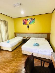 Een bed of bedden in een kamer bij Salang Indah Tioman