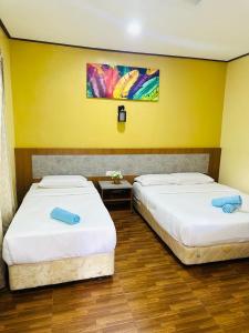Een bed of bedden in een kamer bij Salang Indah Tioman
