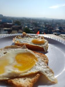 a plate with two fried eggs on top of toast at MOON NIGHT GUEST HOUSE in Jodhpur