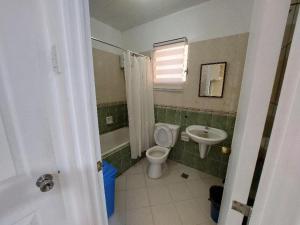 a bathroom with a toilet and a sink at Vacation Town House Near Mactan Cebu Airport in Mactan