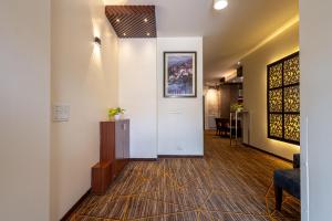 a hallway with a door and a chair and a table at Hotel 91 Golf Course Road in Gurgaon