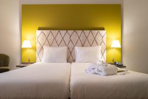 Postel nebo postele na pokoji v ubytování Hotel Au Quartier