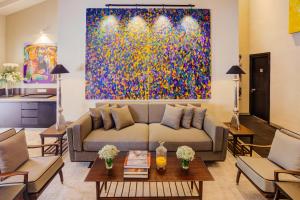 a living room with a couch and a painting at Nyne Hotels - Lake Lodge, Colombo in Colombo