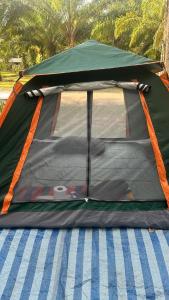 a tent is set up on a street at Khaosok August Freedom Camp in Khao Sok