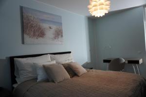 a bedroom with a bed and a chandelier at Easypass Apartmenthotel in Helsinki
