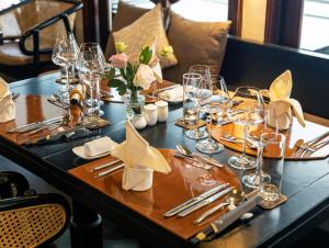 a table with glasses and napkins on top of it at The Au Co Cruise - Longest Cruise 2 Bays in Ha Long