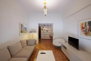 a living room with a couch and a tv at Apartment in the heart of the city in Athens