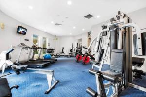 a gym with several treadmills and exercise machines at Landmark Resort Mooloolaba 4th Floor Apartment with a View in Mooloolaba