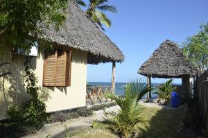 a house on the beach with the ocean in the background at Lui Ushongo Beach House in Pangani