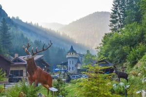 a statue of a deer in front of a building at Horlog Castle in Trigrad