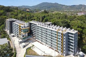 an aerial view of a building with mountains in the background at Central Hill View Condo A716D*2BR Apartment*Ideal Location: Shopping, Relax, Adventure in Ban Ket Ho