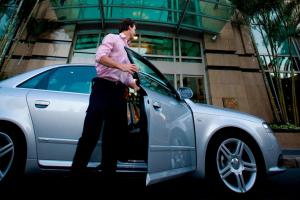 a man is getting out of a car at Brisbane Marriott Hotel in Brisbane