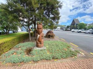 a statue sitting on the side of a street at Rotorua Forest Getaway in Rotorua