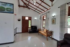 a living room with a couch and a tv at Spacious Greenery Homely Home in Ja-Ela