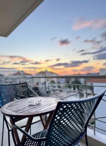 a table and chairs on the balcony of a ship at Uddo Apartment in Komotini