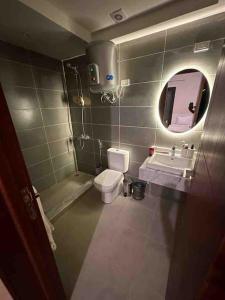 a bathroom with a toilet and a sink and a mirror at Azha 2 bd chalet family only in Ain Sokhna