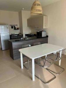 a kitchen with a white table and two chairs at Azha 2 bd chalet family only in Ain Sokhna