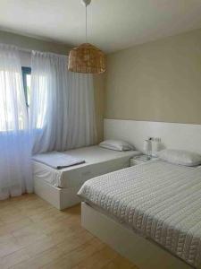 a bedroom with two twin beds and a window at Azha 2 bd chalet family only in Ain Sokhna