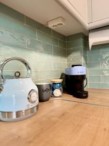 a kitchen counter with a tea kettle and a coffee maker at Uddo Apartment in Komotini