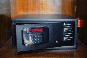 a microwave oven with a clock on top of it at Sol Y Viento Mountain Hot Springs Resort in Calamba