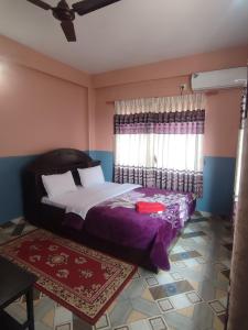 A bed or beds in a room at Krishna Inn
