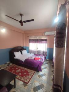 A bed or beds in a room at Krishna Inn