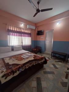 A bed or beds in a room at Krishna Inn