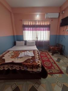 A bed or beds in a room at Krishna Inn