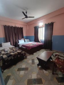 A bed or beds in a room at Krishna Inn
