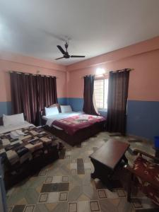 A bed or beds in a room at Krishna Inn