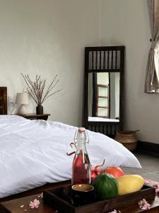 a tray of fruit on a table next to a bed at Anio Ha Giang Hotel in Ha Giang