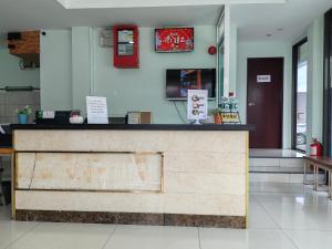 a restaurant with a counter in a room at Hotel Prima in Sandakan