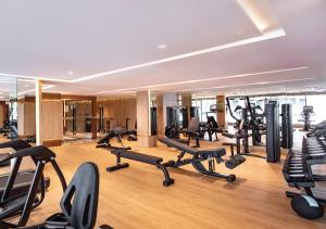 a gym with a lot of exercise bikes and treadmills at SAMALA Hotel Bangkok in Bangkok