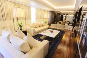 a living room with white couches and a table at Avari Tower Karachi in Karachi