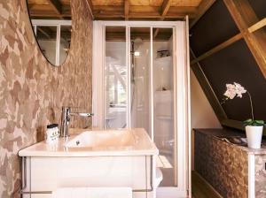 a bathroom with a sink and a mirror at Club del Sole Rimini Family Resort in Rimini